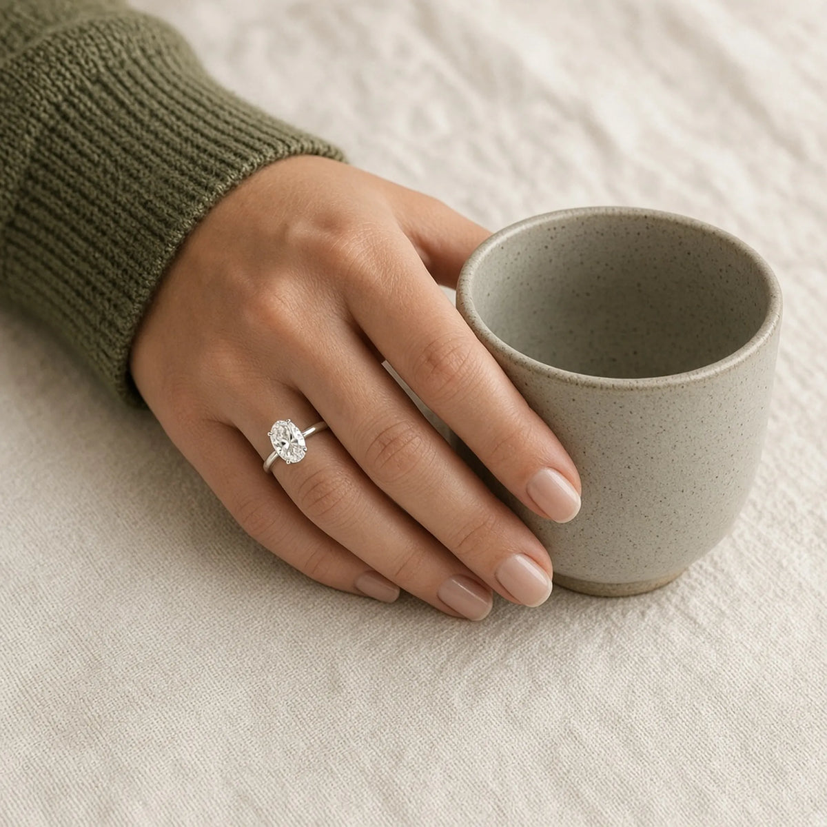 1.09 ct oval lab-grown diamond, D colour, VVS2 clarity, Excellent polish, worn in an 18K white gold solitaire, lifestyle