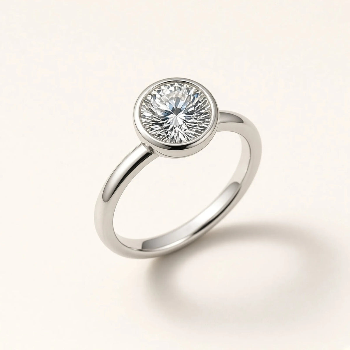 Bezel-set engagement ring in 18K white gold with a round lab-grown diamond, three-quarter view