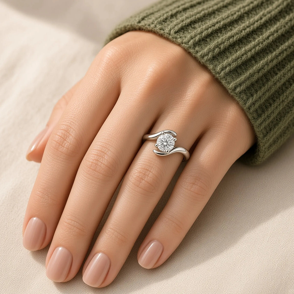 Sculptural bypass ring in 18K white gold with a four-prong round lab-grown diamond, worn on the left hand