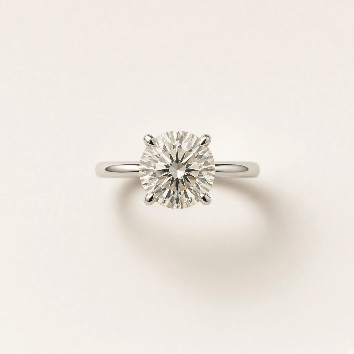 Four-prong solitaire engagement ring in 18K white gold, face-up view