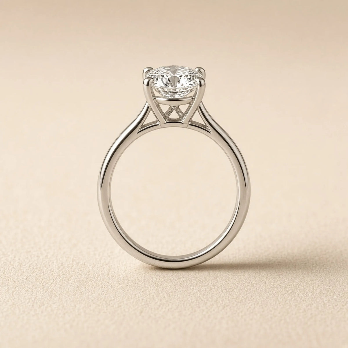 Four-prong solitaire engagement ring in 18K white gold, side profile showing setting height and gallery