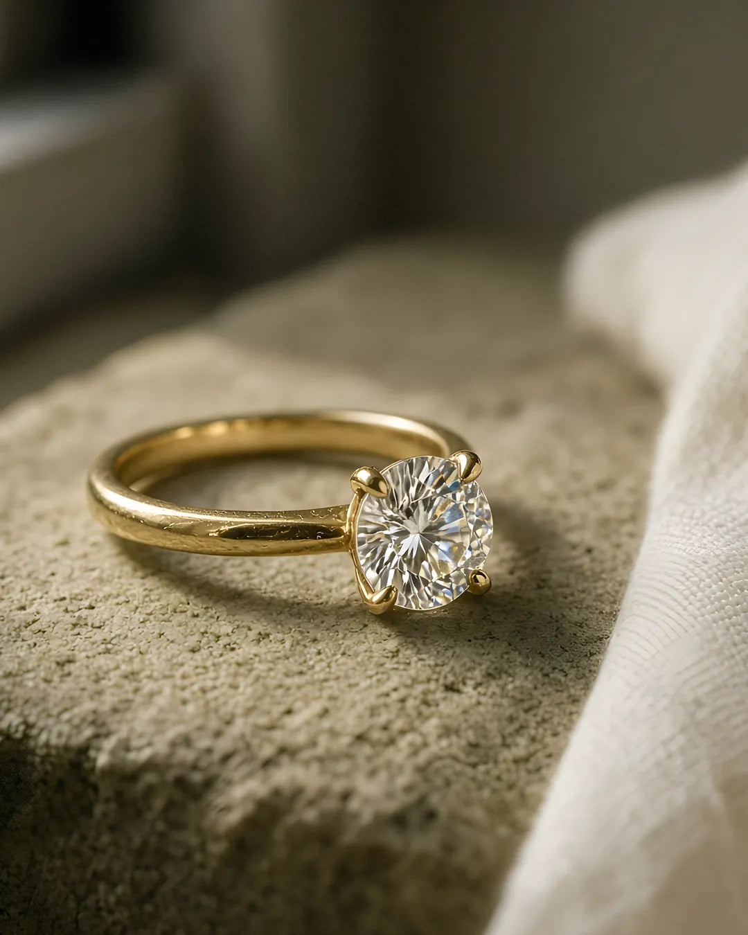 Yellow gold four-claw round solitaire engagement ring macro Yellow gold four-claw round solitaire engagement ring macro