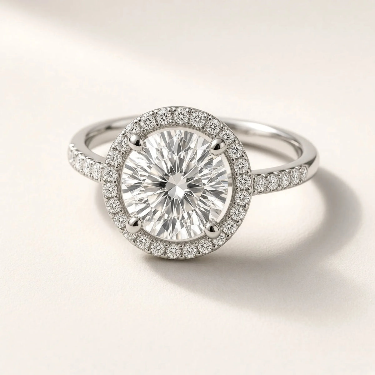 Halo engagement ring in 18K white gold with a four-prong round lab-grown diamond and pave halo, three-quarter view