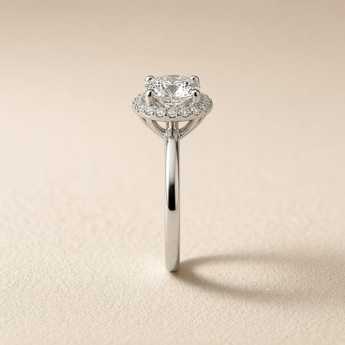 Halo engagement ring in 18K white gold, side profile showing the halo and gallery
