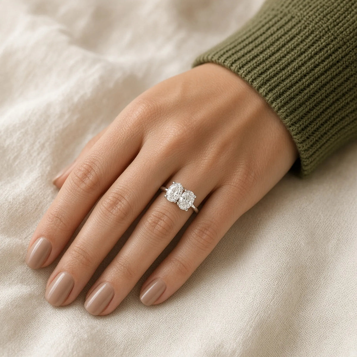 Toi et moi ring in 18K white gold with two oval lab-grown diamonds, worn on the left hand